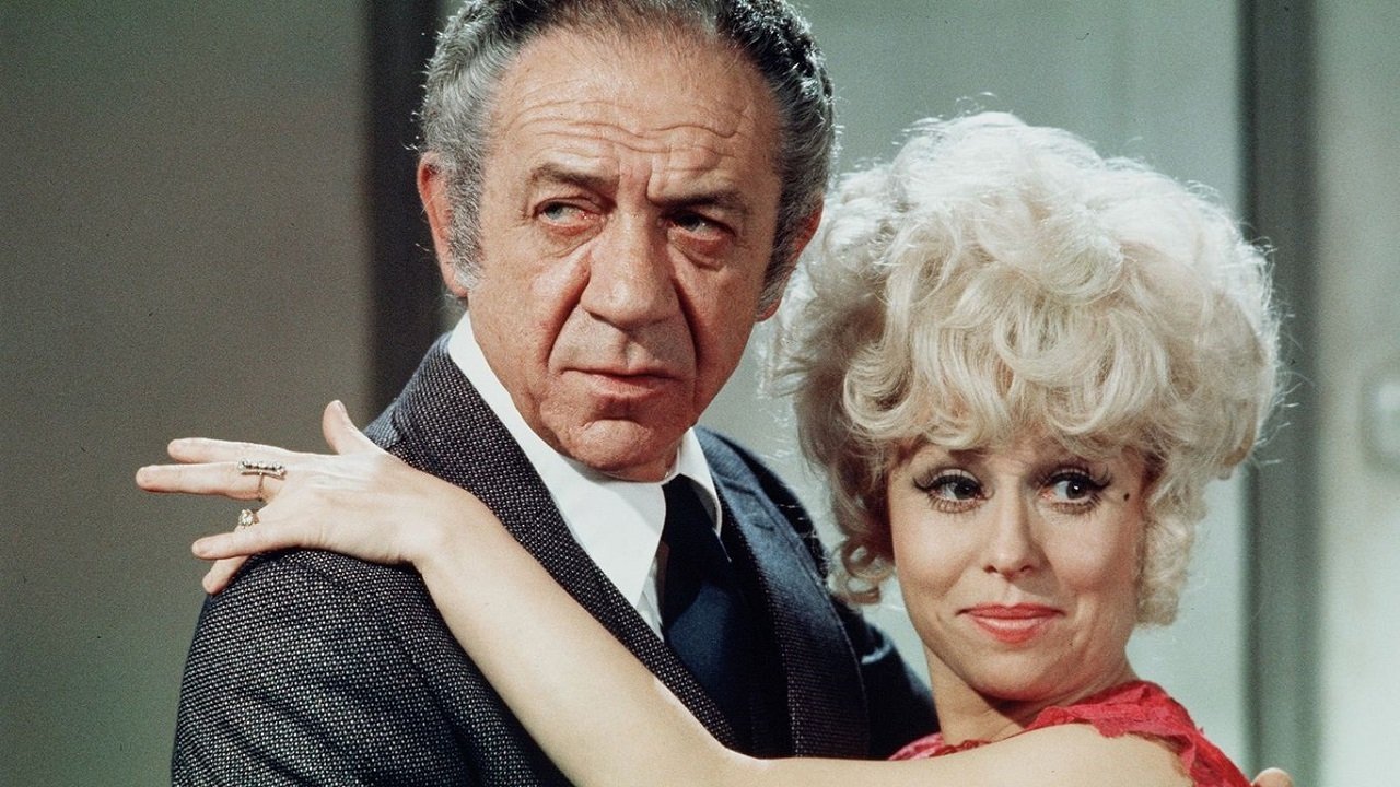 Sid James wearing Breitling Top Time in Carry On Girls