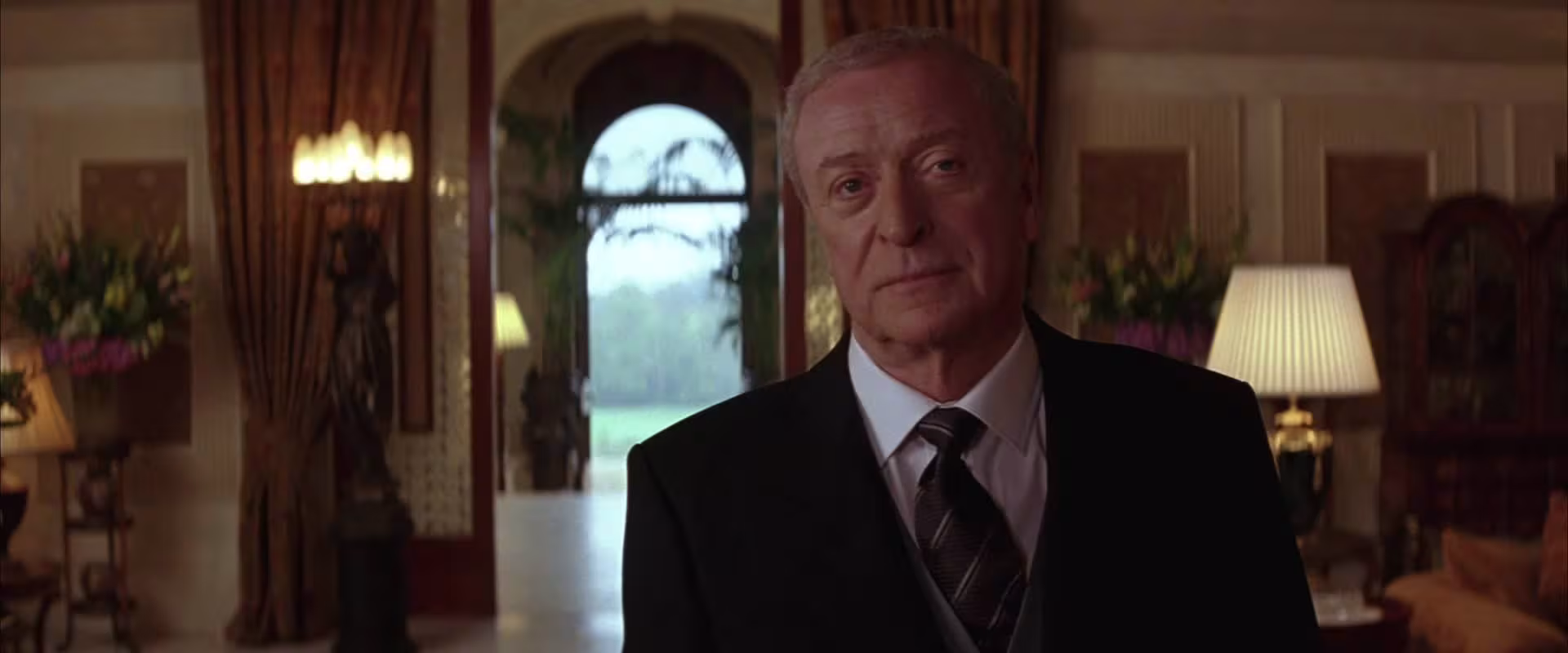 Michael Caine wearing Traser Black Storm Pro in Batman Begins