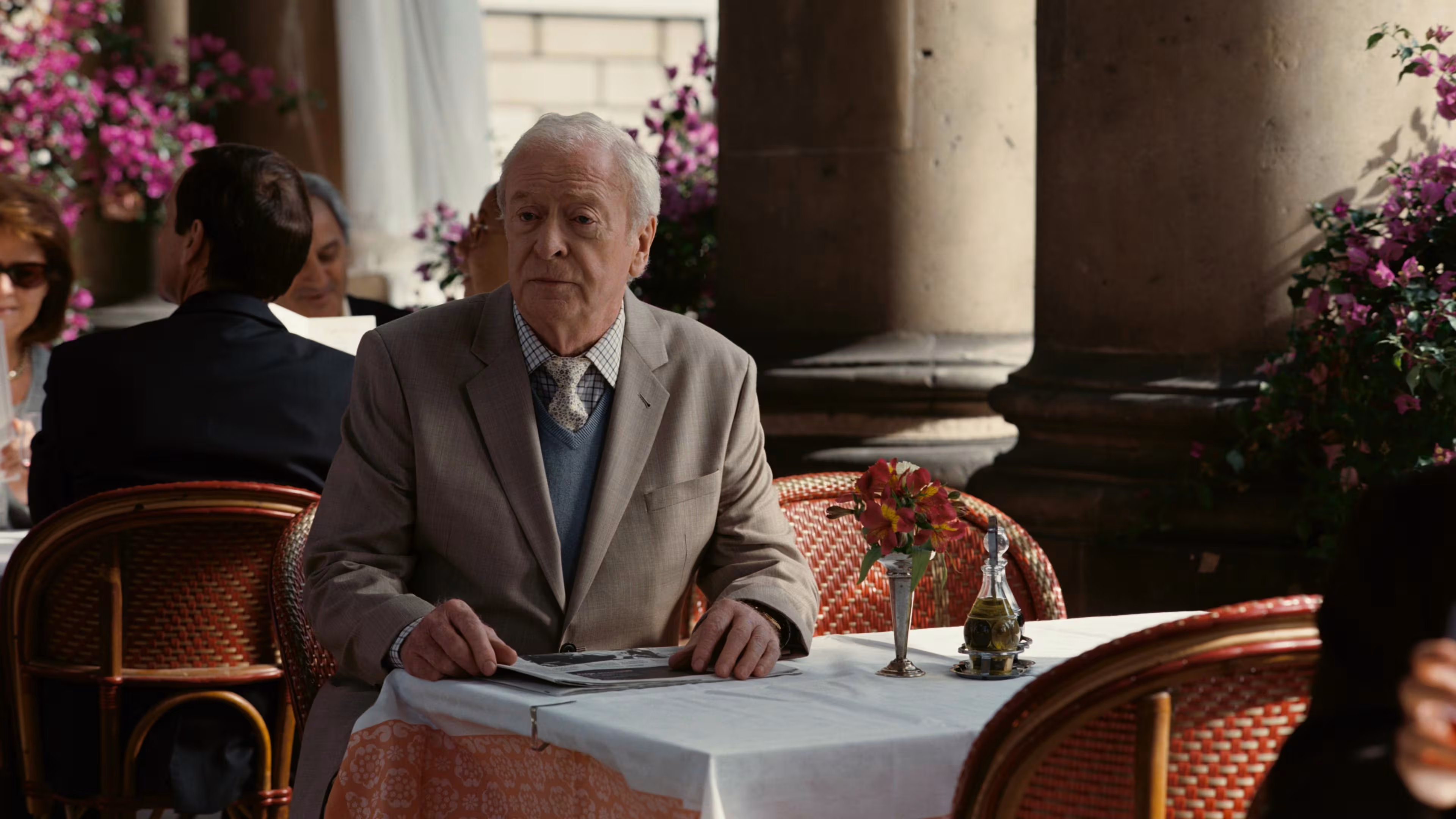 Michael Caine wearing Traser Black Storm Pro in The Dark Knight Rises